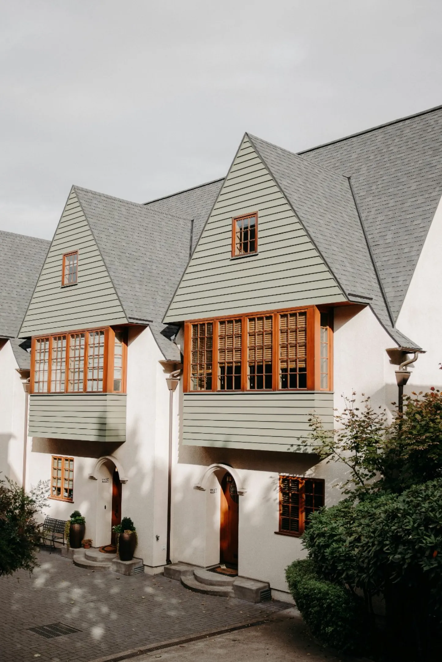 A white house with a black roof and a window with a white frame.