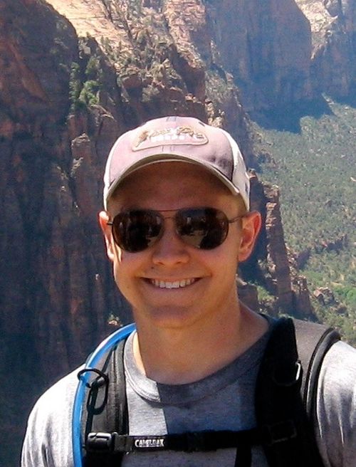 Joel Malkin standing on a hike with the Grand Canyon in the background.