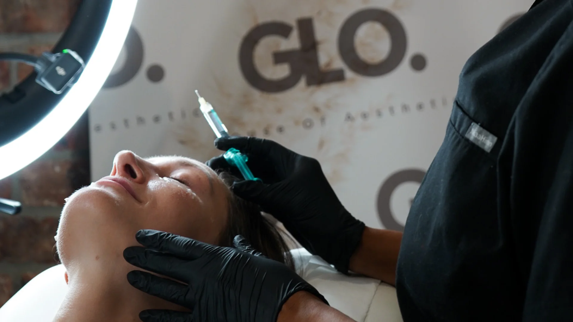 Rosie from GLO preparing to carefully administer a polynucleotides injection on client.