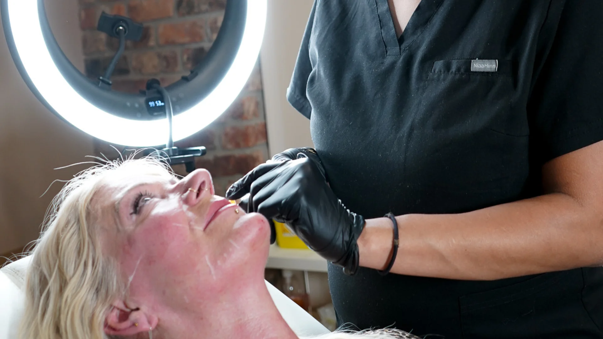 Rosie from GLO preparing a client’s skin with a targeted treatment product as part of their personalised skin reset plan.