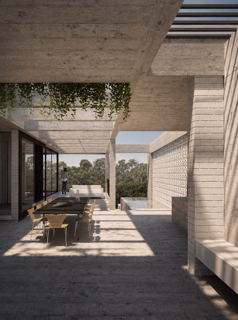 Covered outdoor dining terrace with concrete pergola and filtered natural light at Vaucluse I.