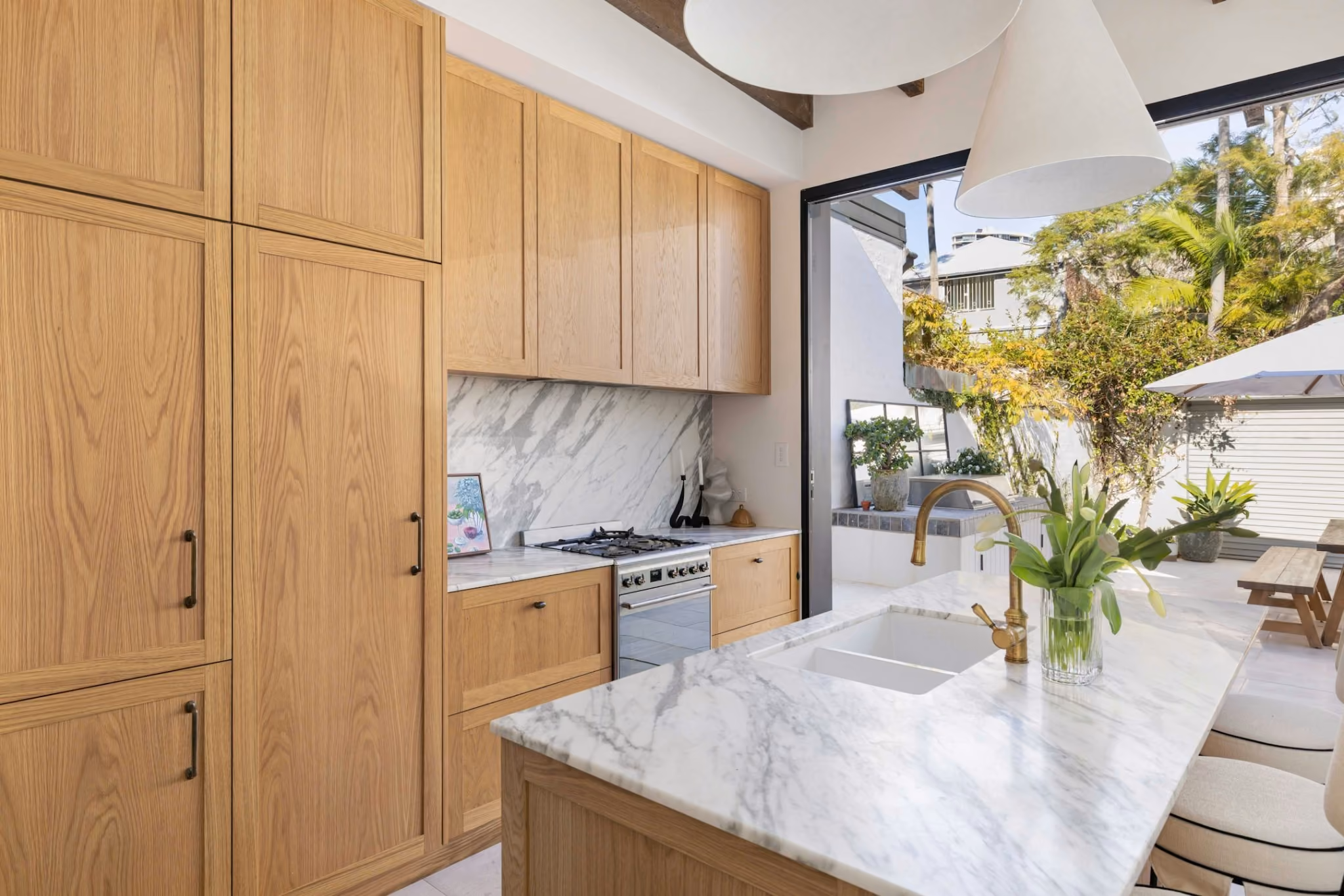 Natural oak kitchen cabinetry and marble benchtops within a light-filled heritage terrace renovation in Woollahra.