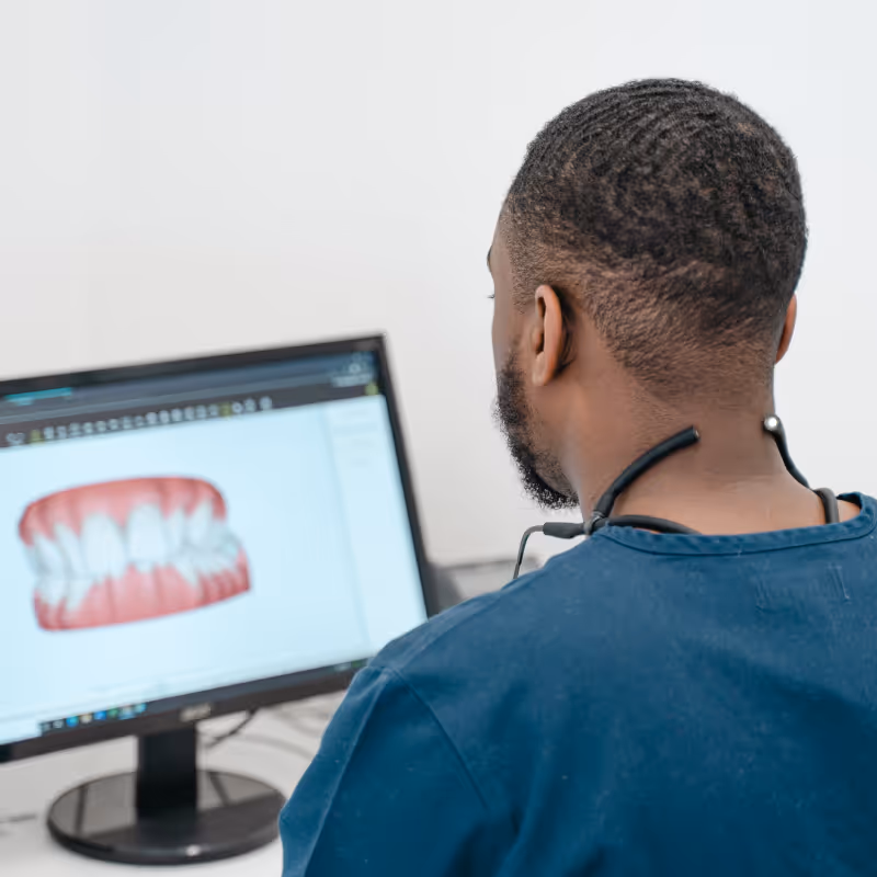 Dentist looking at computer
