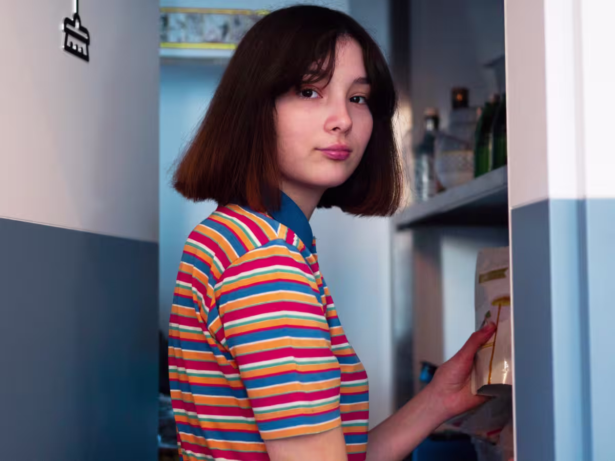 young girl looking in cabinet