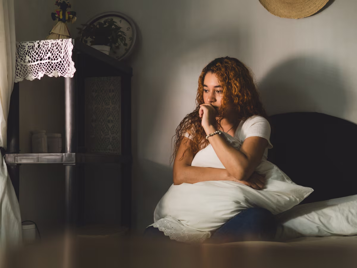 young girl sitting on bed