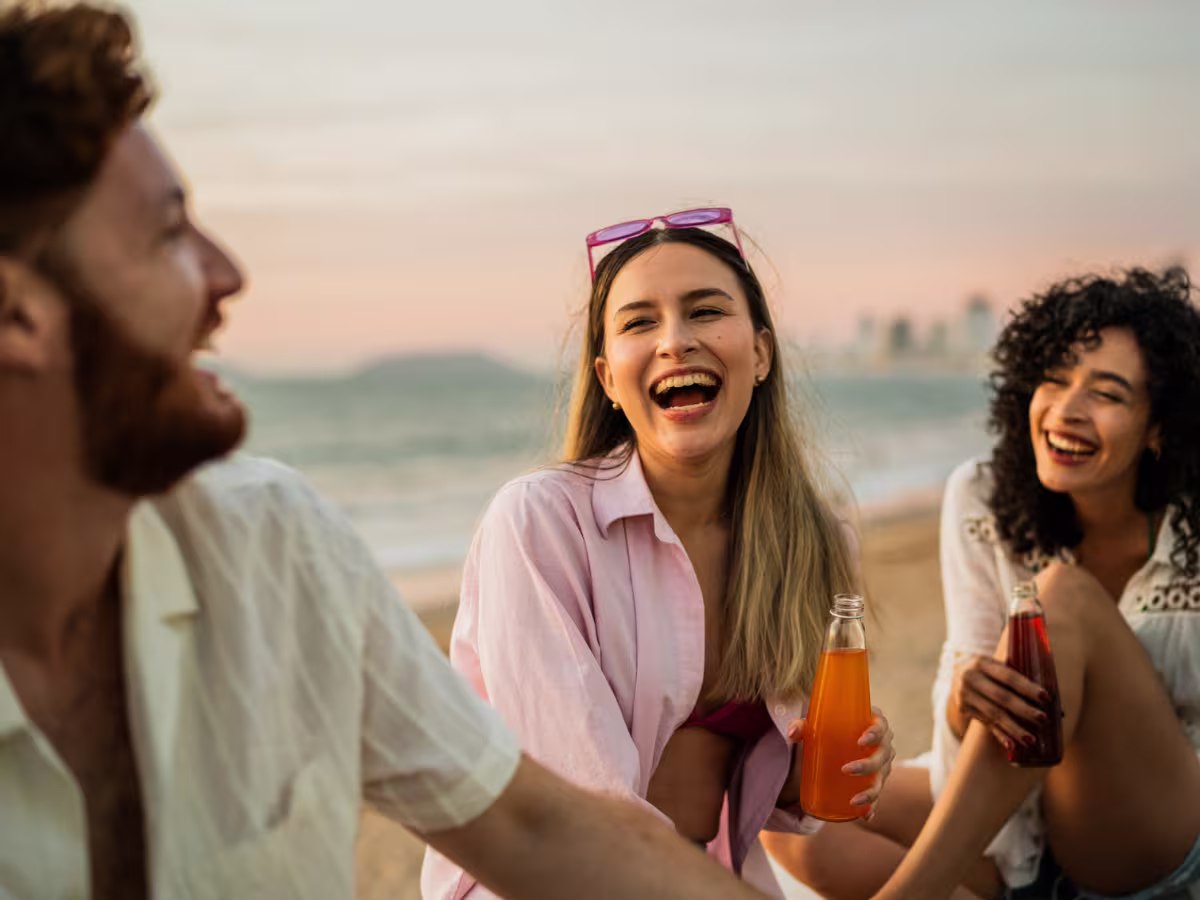 friends at the beach drinking soda