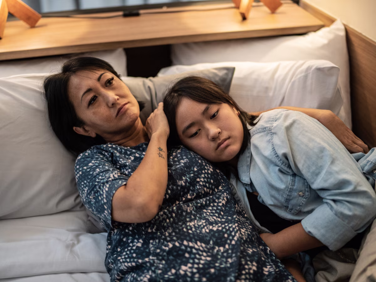 mom and daughter sitting on couch