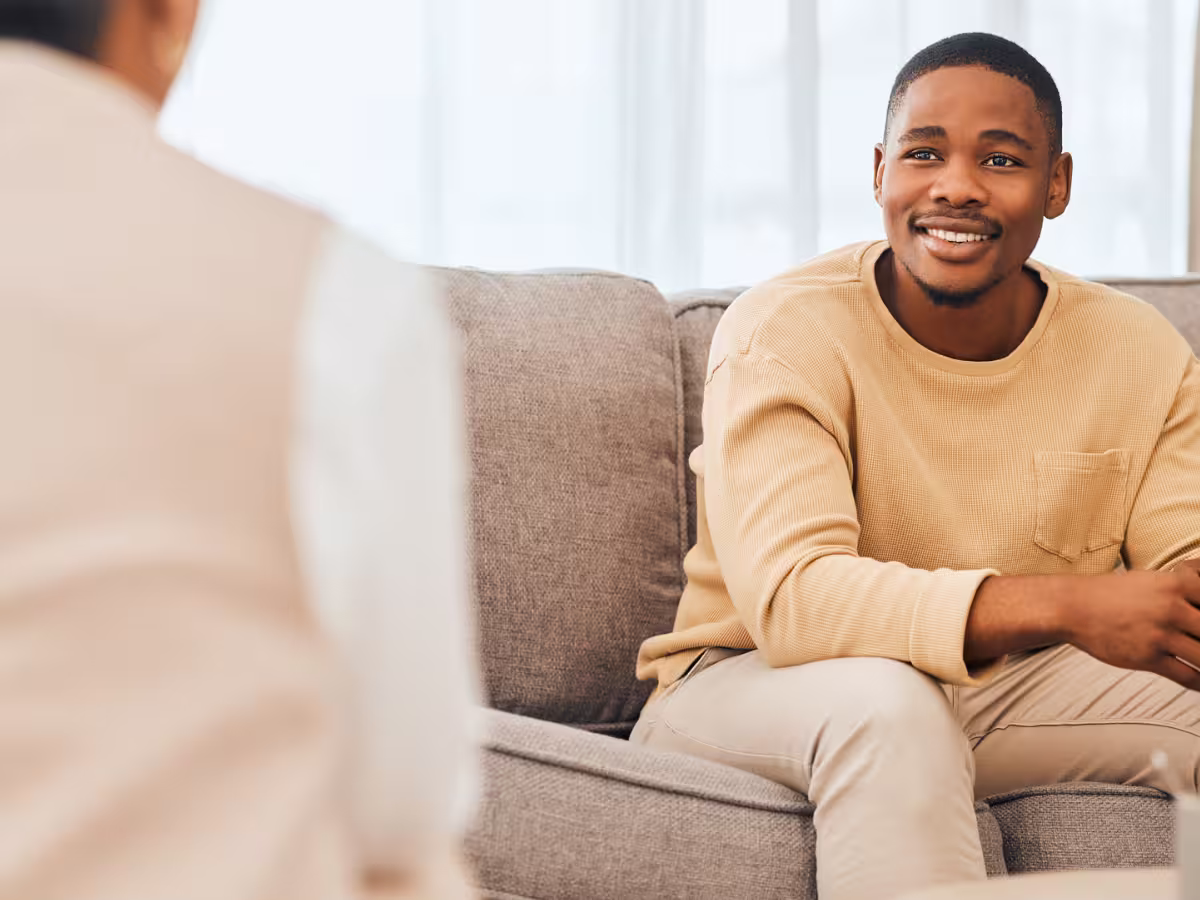 man sitting on couch in therapy