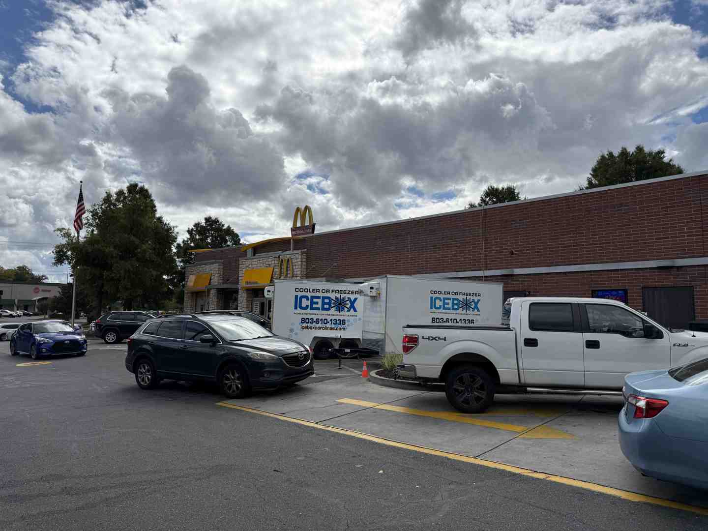 Icebox delivery driver positioning a freezer trailer in a tight parking lot - rent portable freezer