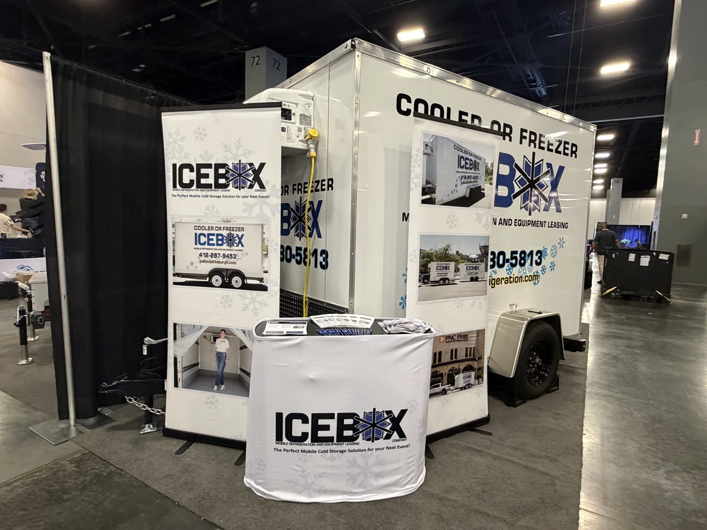 small walk-in cooler trailer parked on-site at commercial event