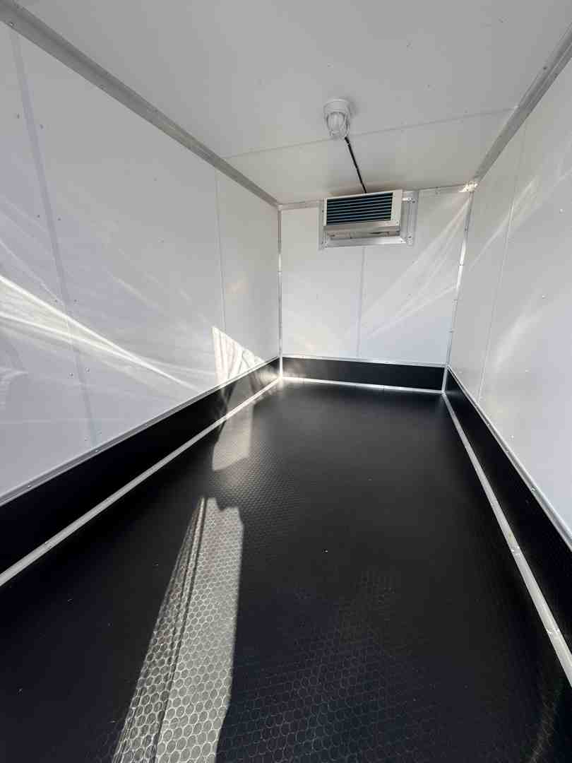 Interior view of a mobile cooler trailer showing flat flooring and bright LED lighting Interior view of a mobile cooler trailer showing flat flooring and bright LED lighting