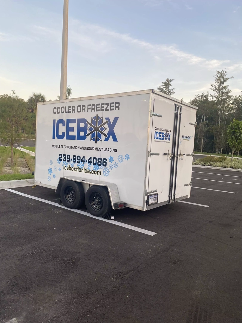 A clean, modern mobile freezer trailer parked at an outdoor event