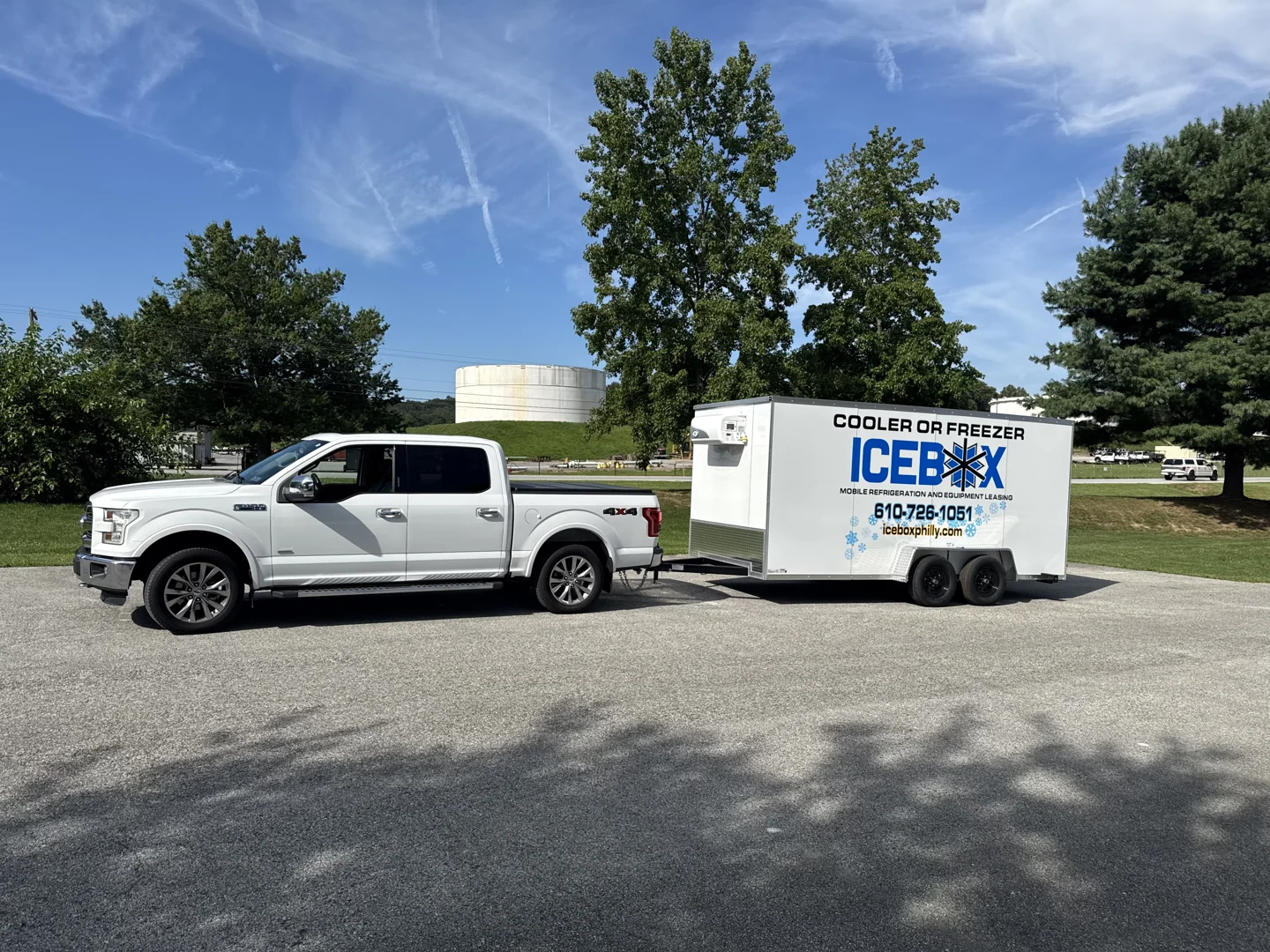 An Icebox delivery truck towing a clean mobile refrigeration trailer to a commercial site An Icebox delivery truck towing a clean mobile refrigeration trailer to a commercial site