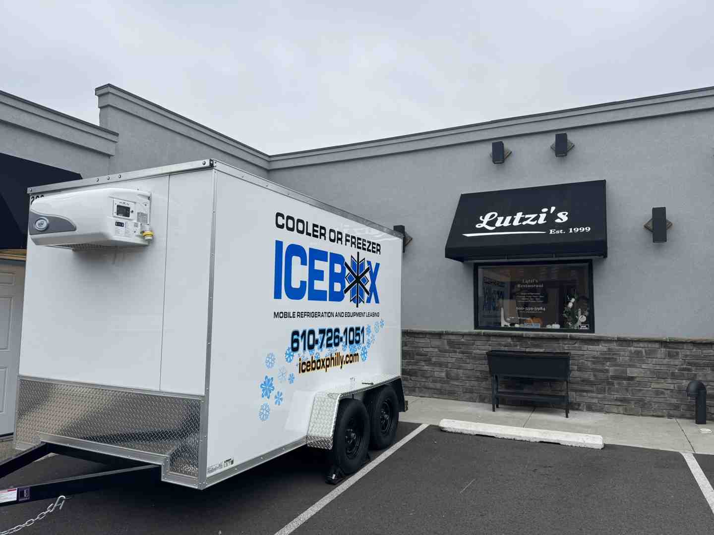 A clean, modern 110V mobile cooler trailer parked outside a busy Pennsylvania restaurant A clean, modern 110V mobile cooler trailer parked outside a busy Pennsylvania restaurant
