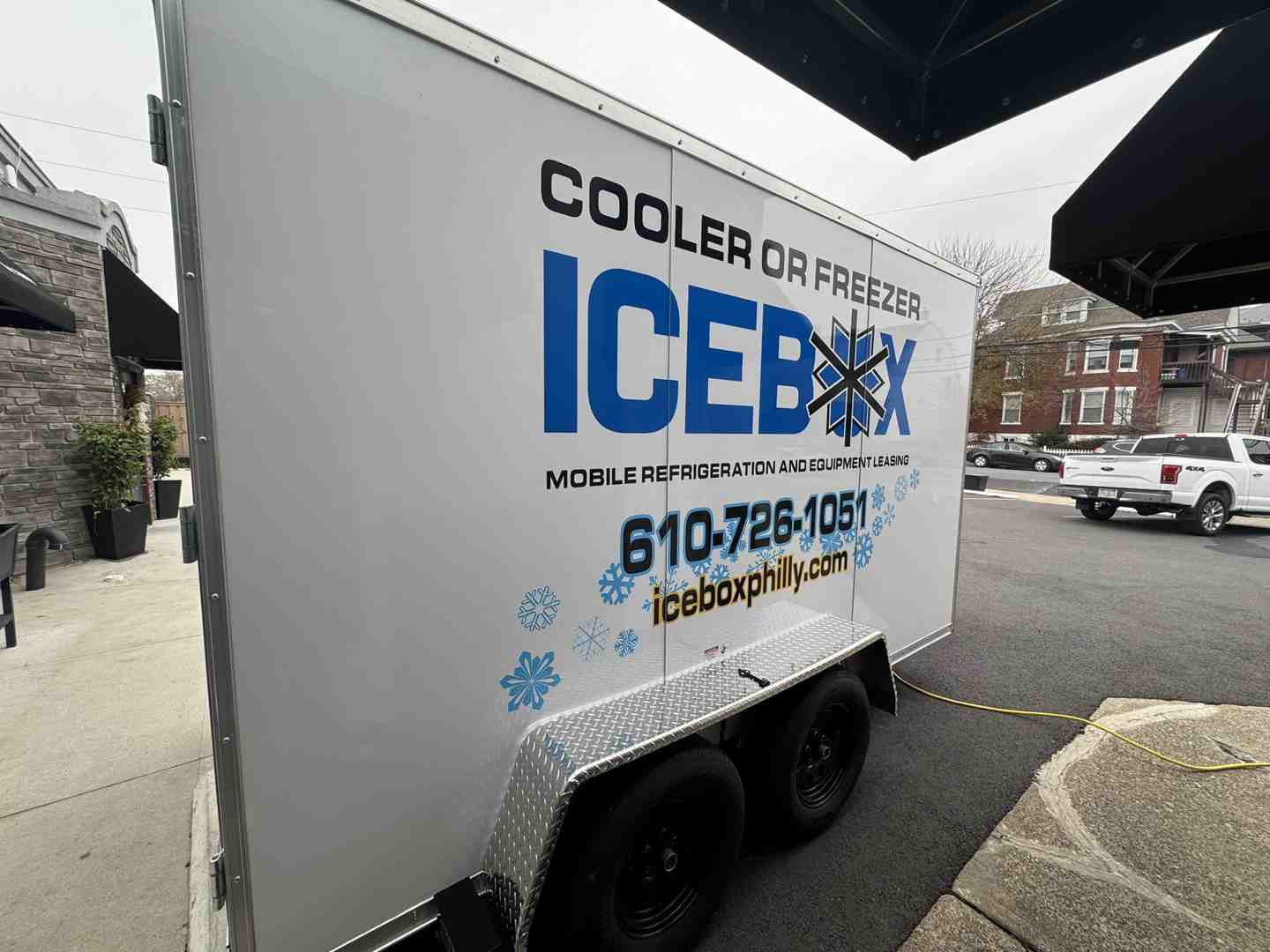Icebox technician setting up a mobile cooler trailer on-site Icebox technician setting up a mobile cooler trailer on-site