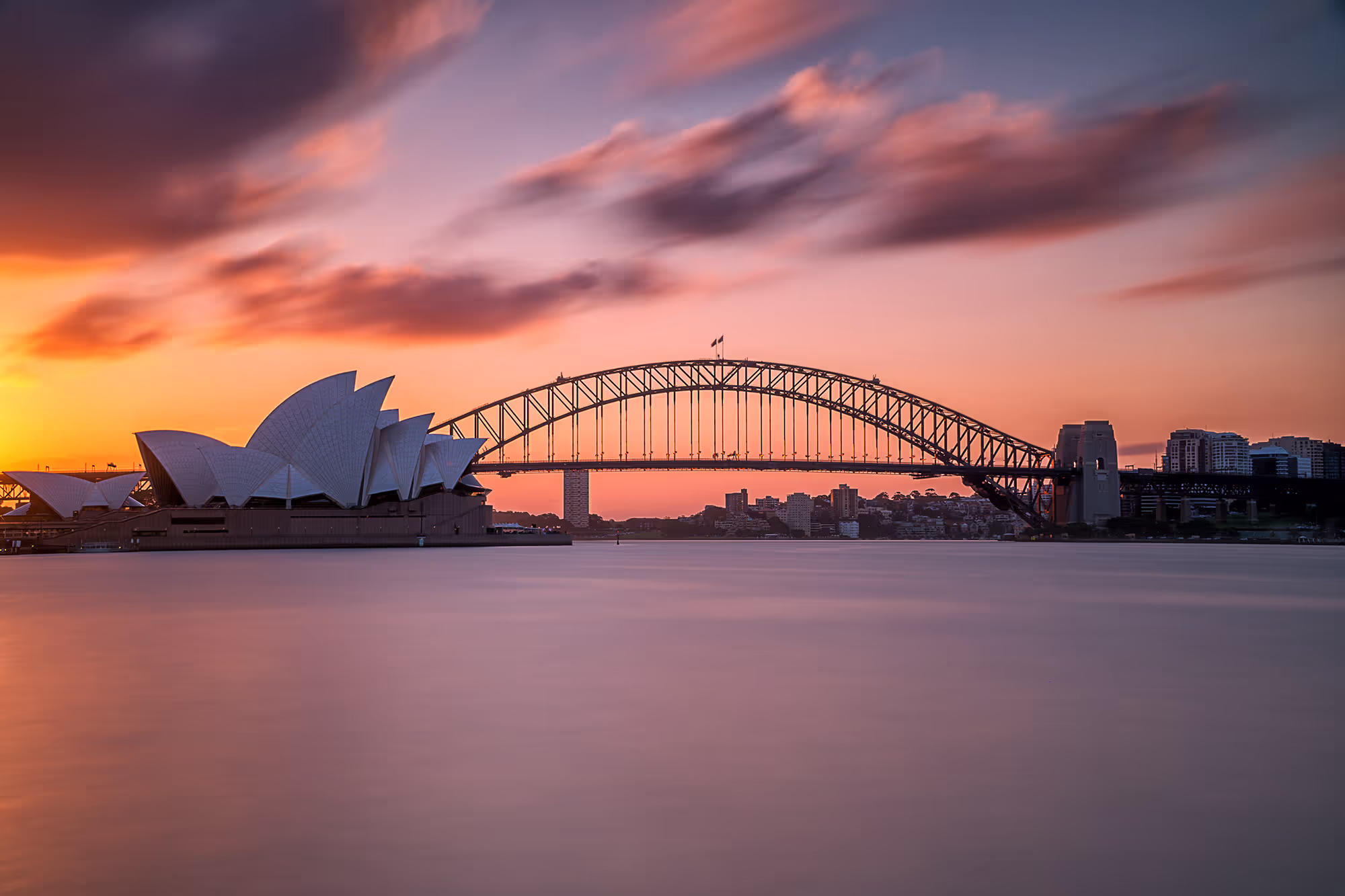 Sydney Harbour Bridge and Opera House lit up at night