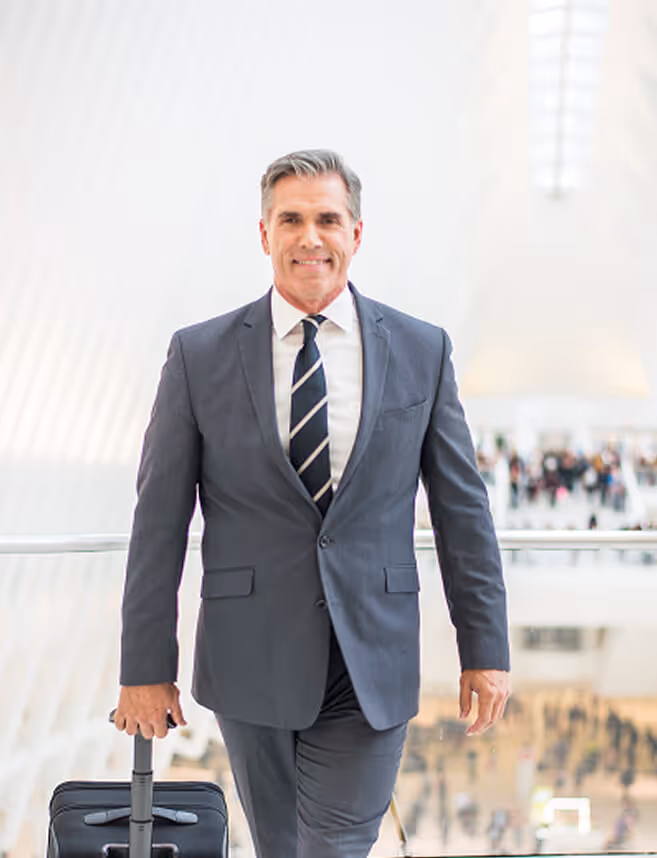 businessman smiling going to the airport