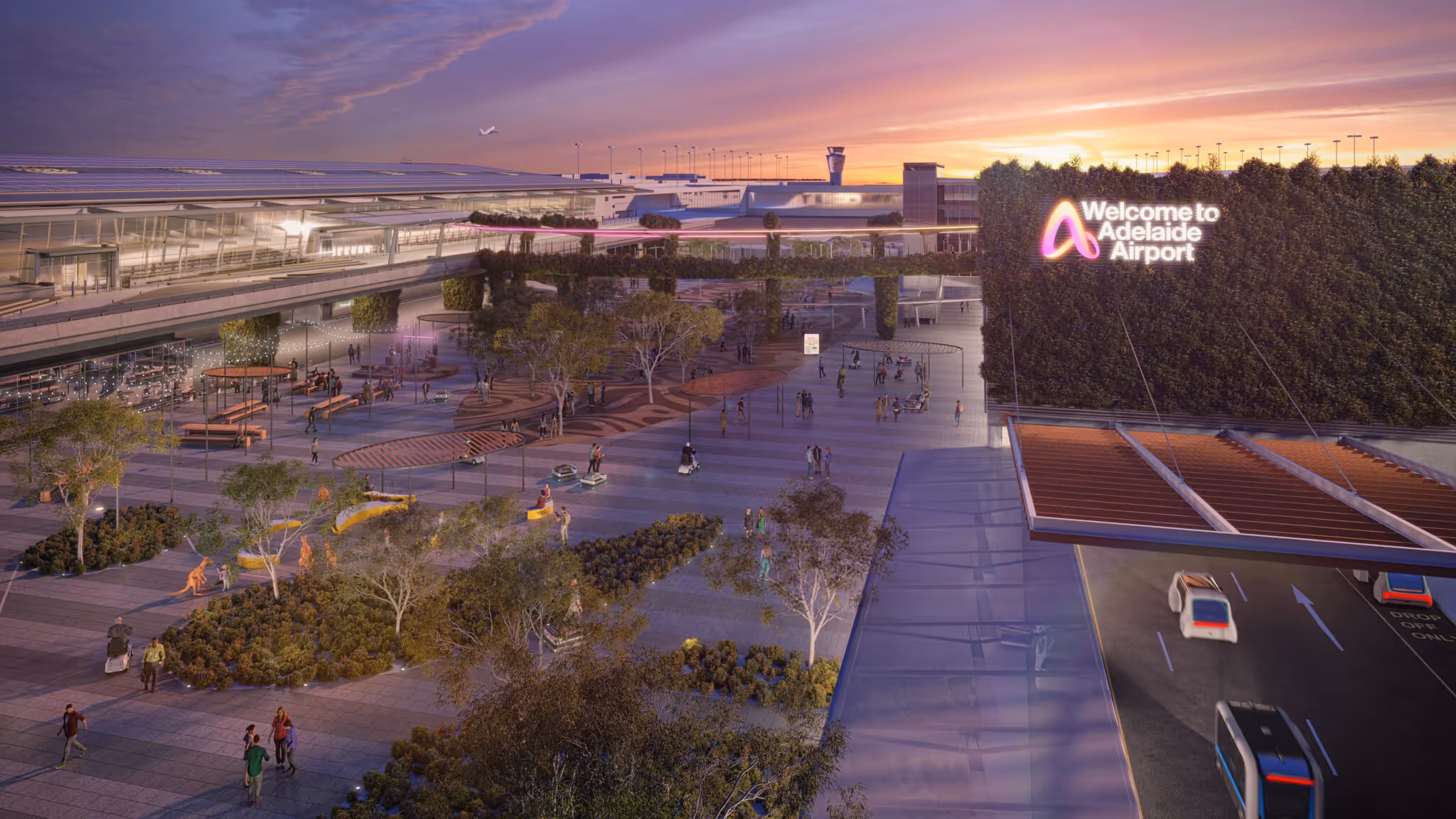 Sunset view of Adelaide Airport entrance with pedestrian plaza, greenery, and vehicles on the drop-off road.