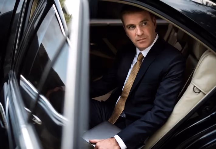 Passenger seated in the back of a chauffeured car