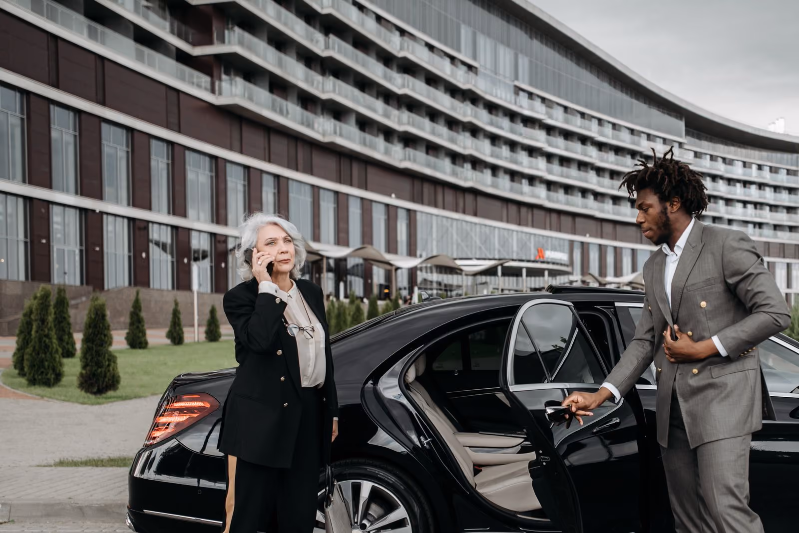 Chauffeur loading luggage into a car boot