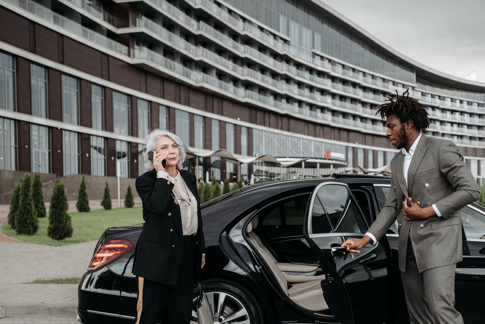 Chauffeur loading luggage into a car boot