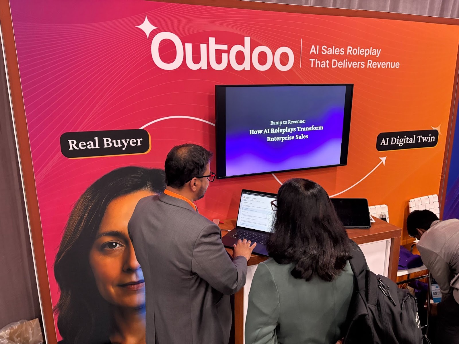 Snehal Nimje, CEO of Outdoo demonstrating the AI Sales Roleplay platform to a visitor at the Dreamforce 2025 booth, highlighting how AI transforms enterprise sales.