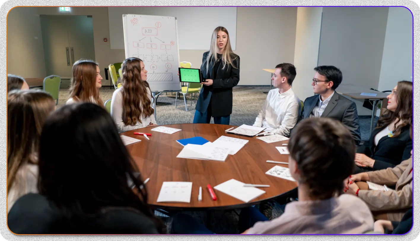 A group of people actively listening to speaker in an office meeting