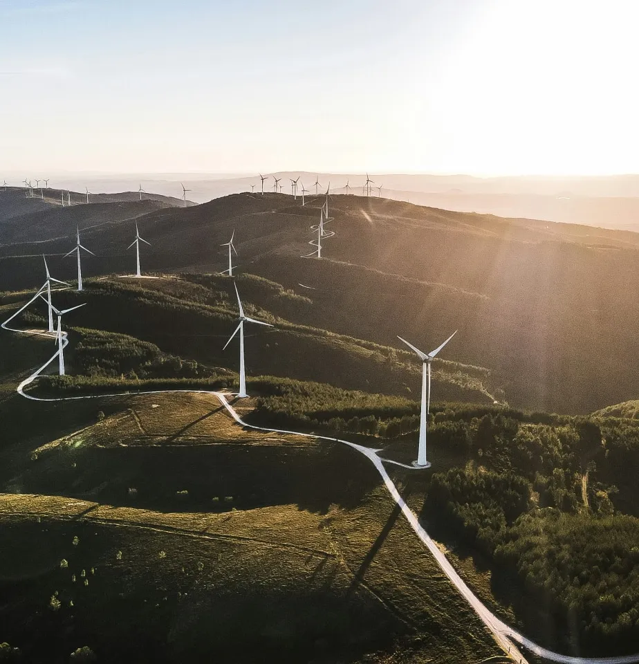 a group of wind turbines on a hillside
