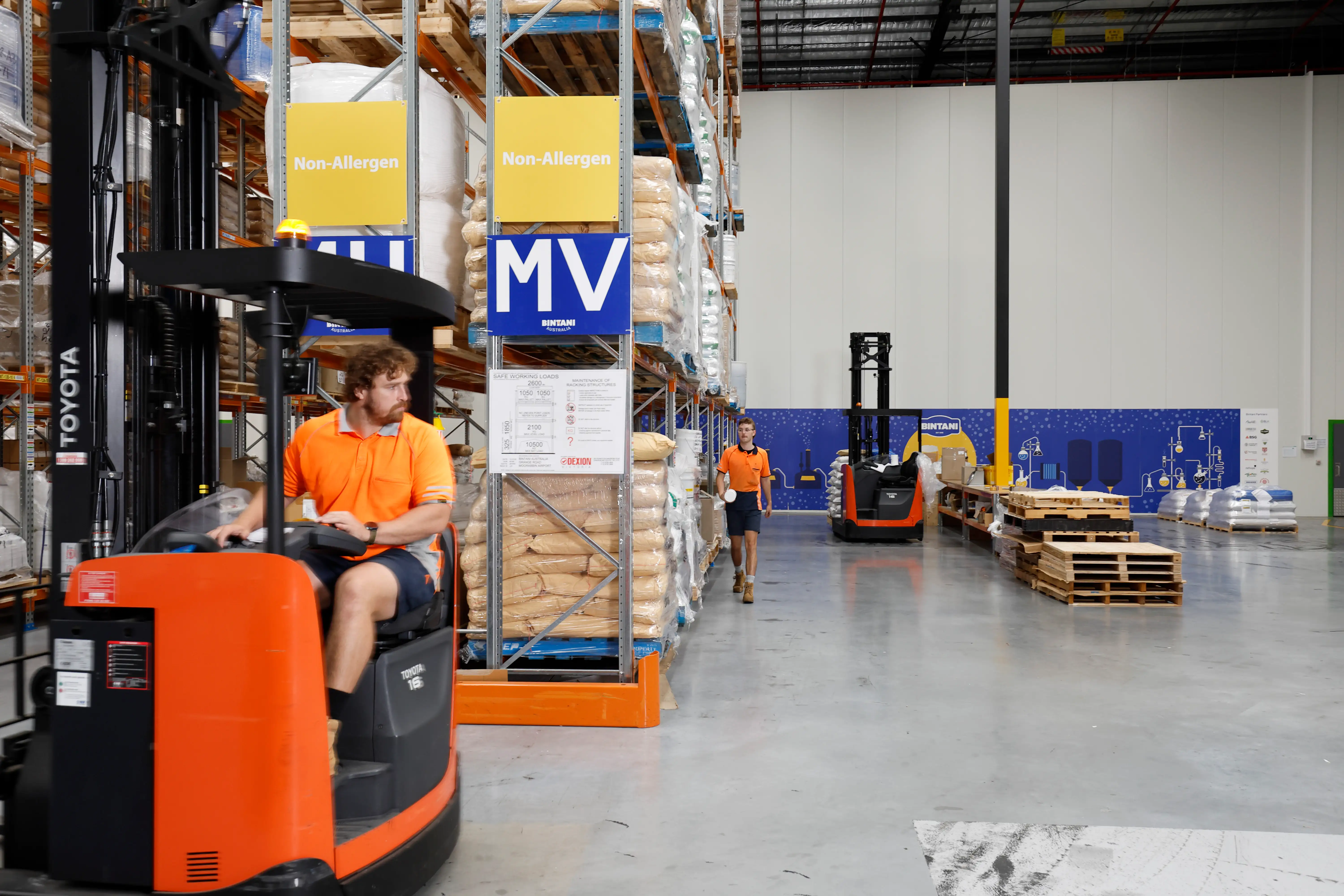a man driving a forklift in a warehouse