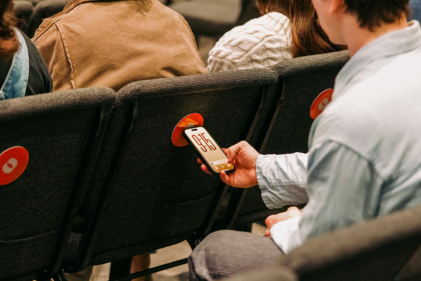 Man tapping his phone on an NFC device