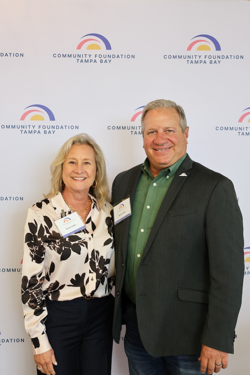 Woman and man standing in front of CFTB backdrop