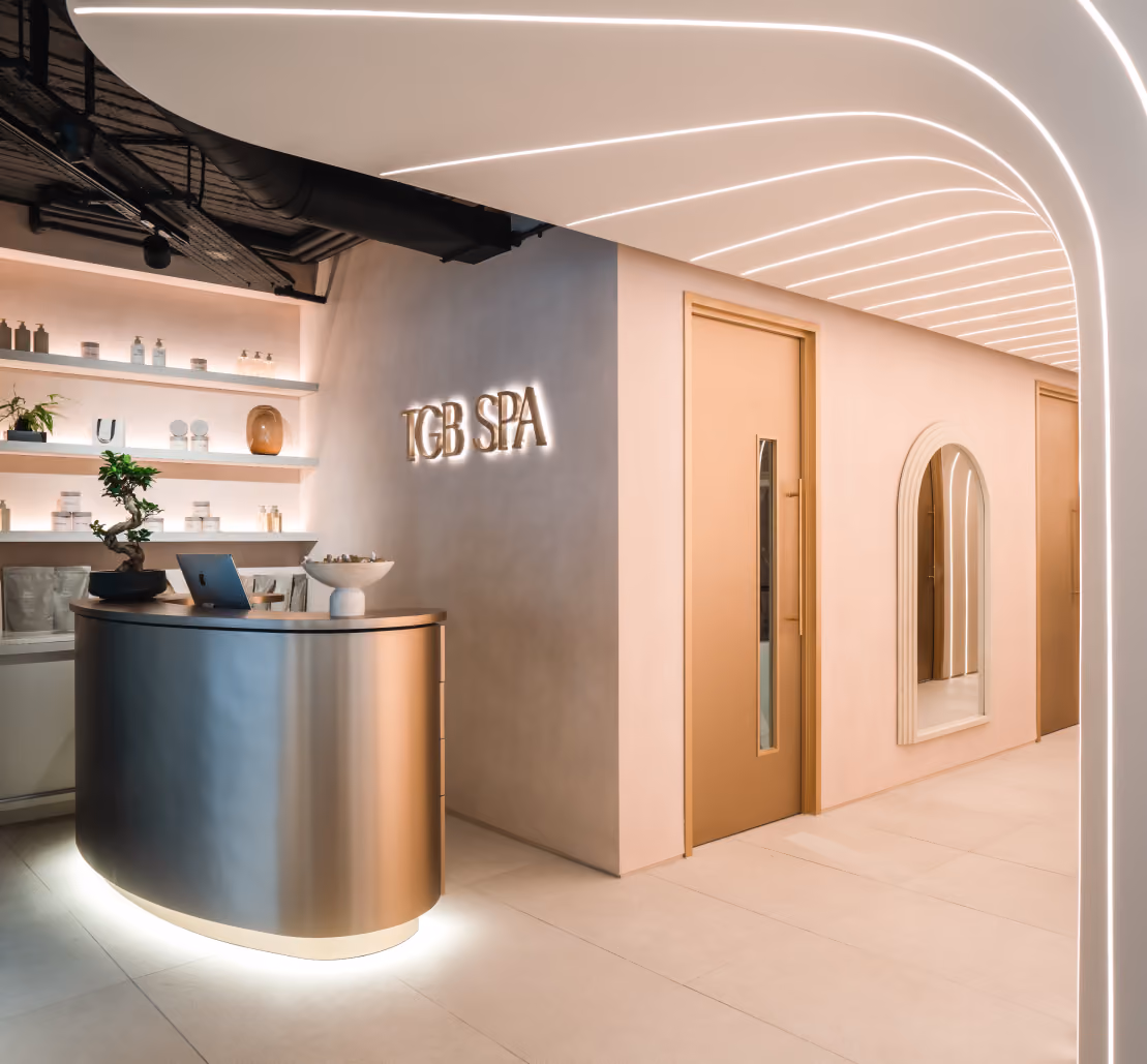 Reception desk with the TGB Spa logo on the wall at the spa in Brighton