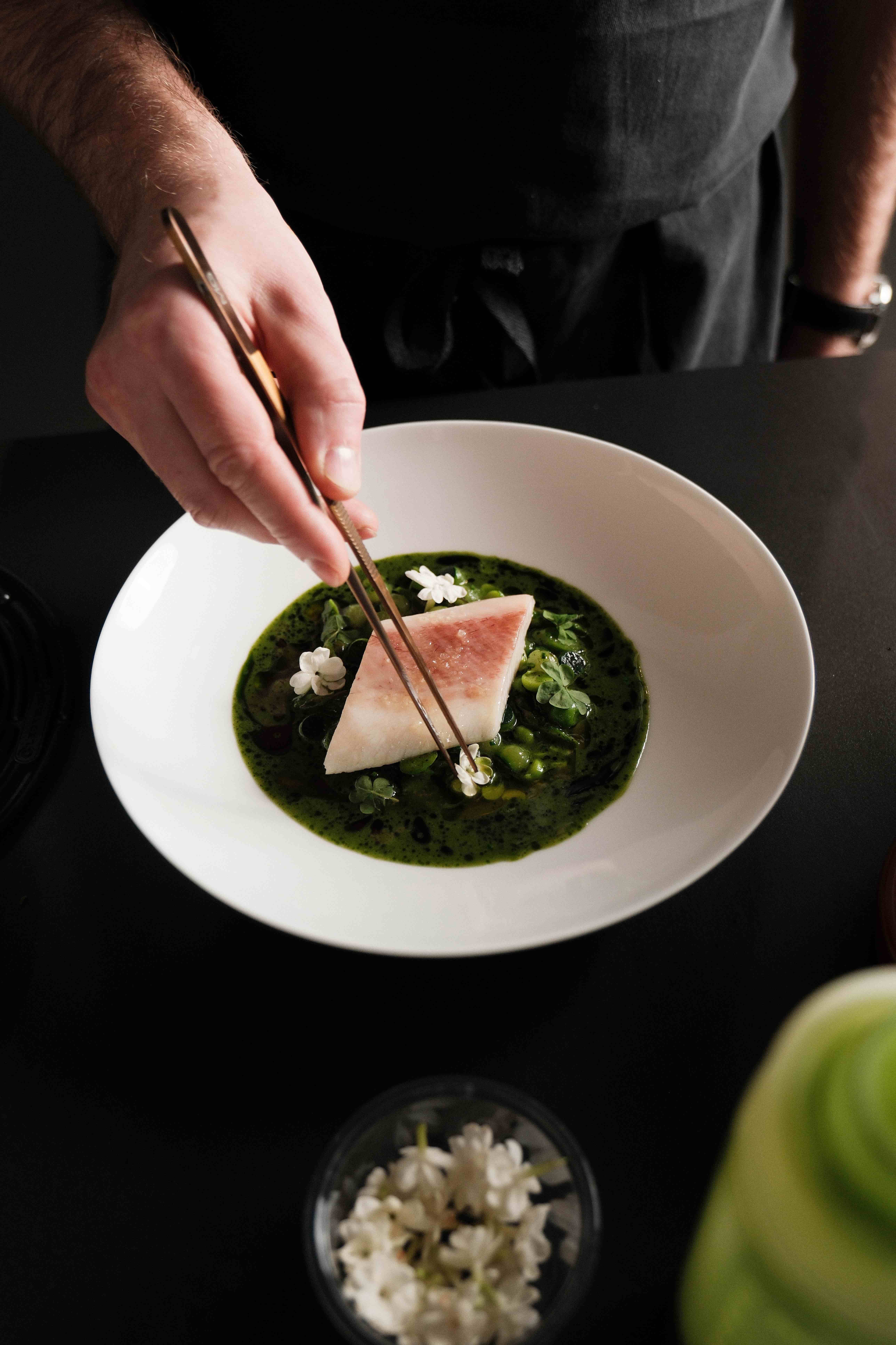 A private chef plates a fine dining course during a hosted catered chalet holiday in the Alps