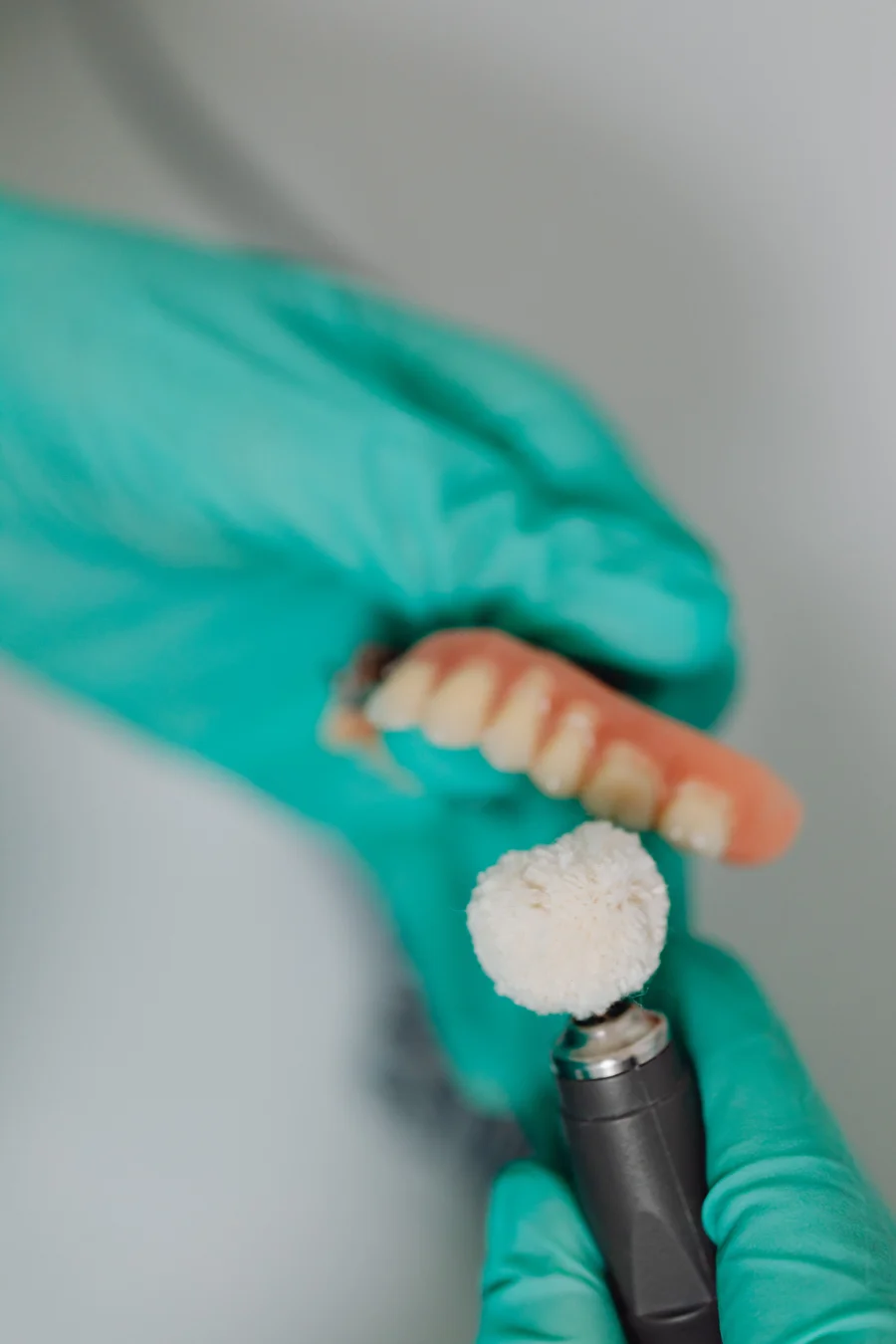dentures-birmingham-al-technician-polishing-denture-in-dental-lab