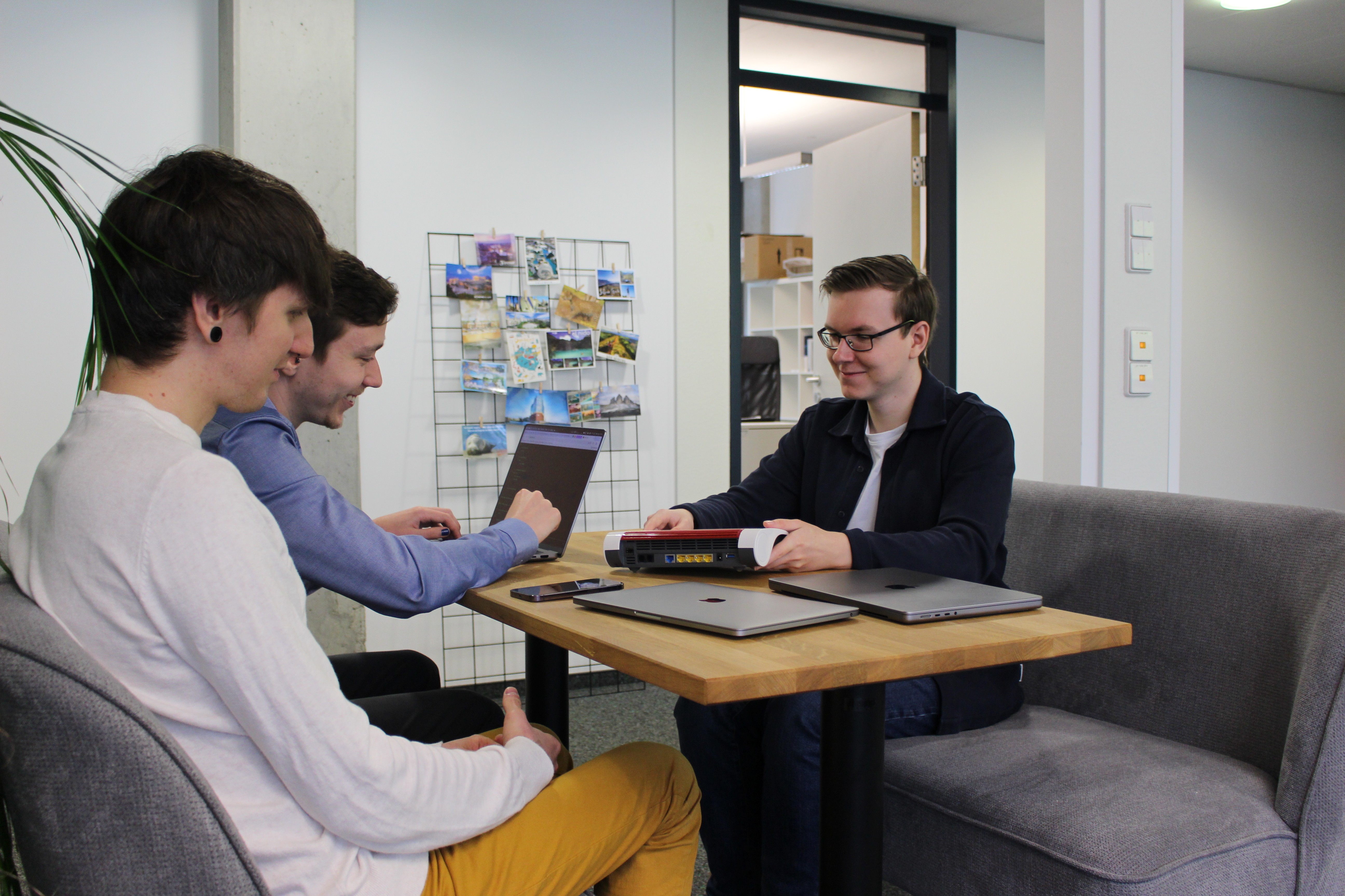 Three employee sitting down and working together 