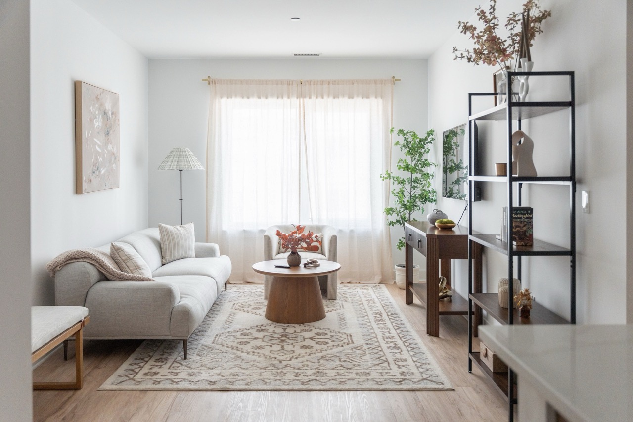 Spacious living room with large windows and city view at The Lafayette Stamford