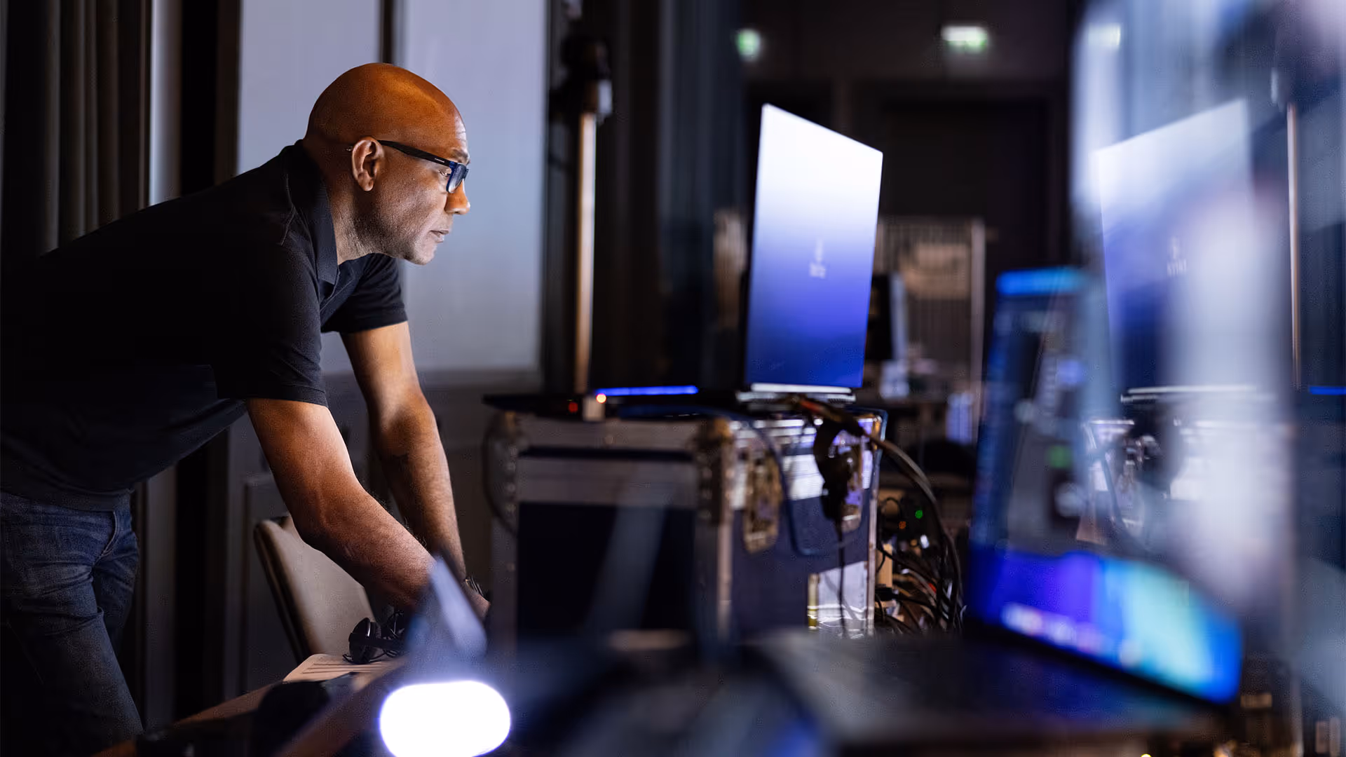 Producer checking technical equipment before meeting starts.