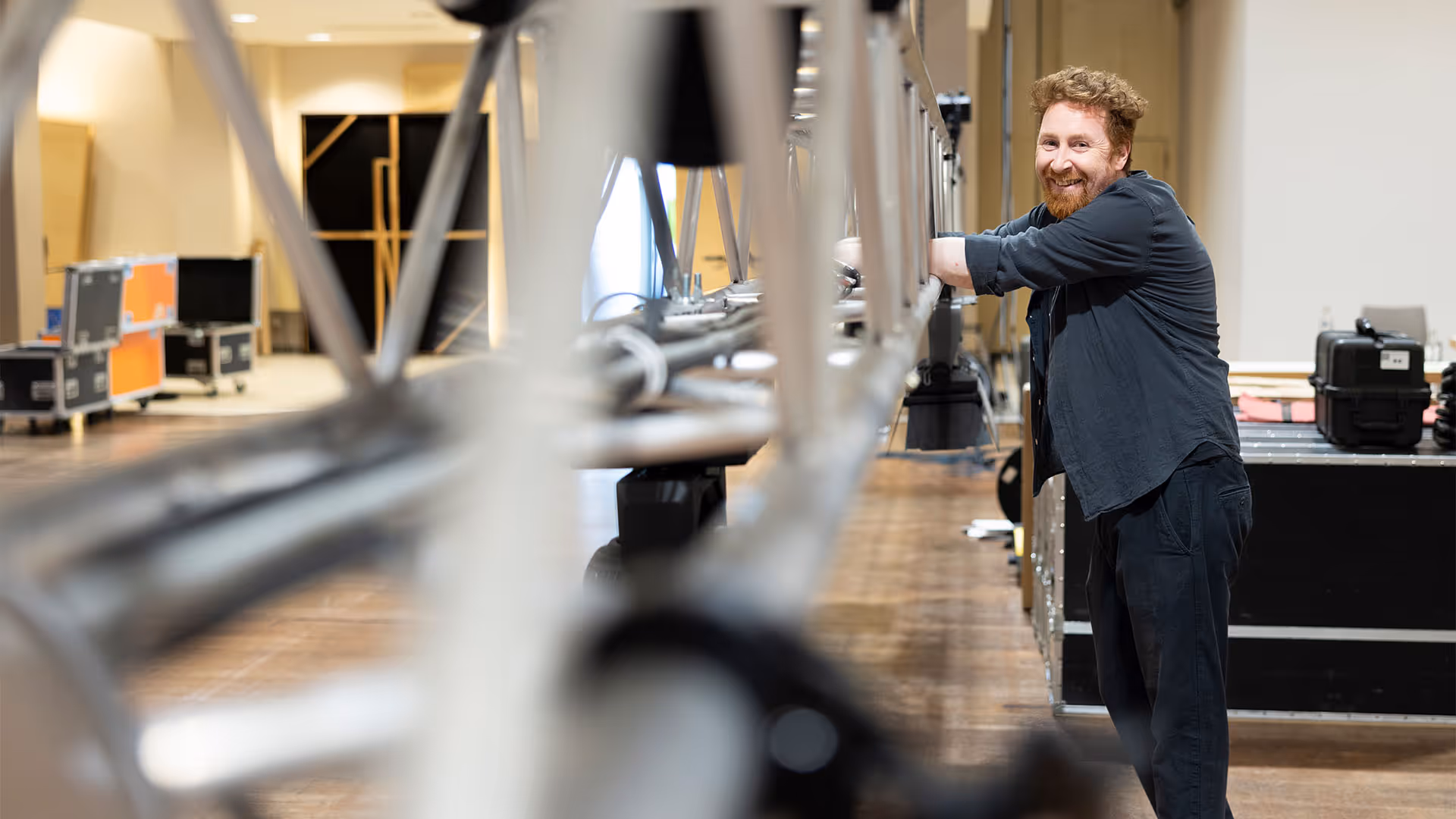 Karl Travers, Projects Director, onsite smiling near event rigging.