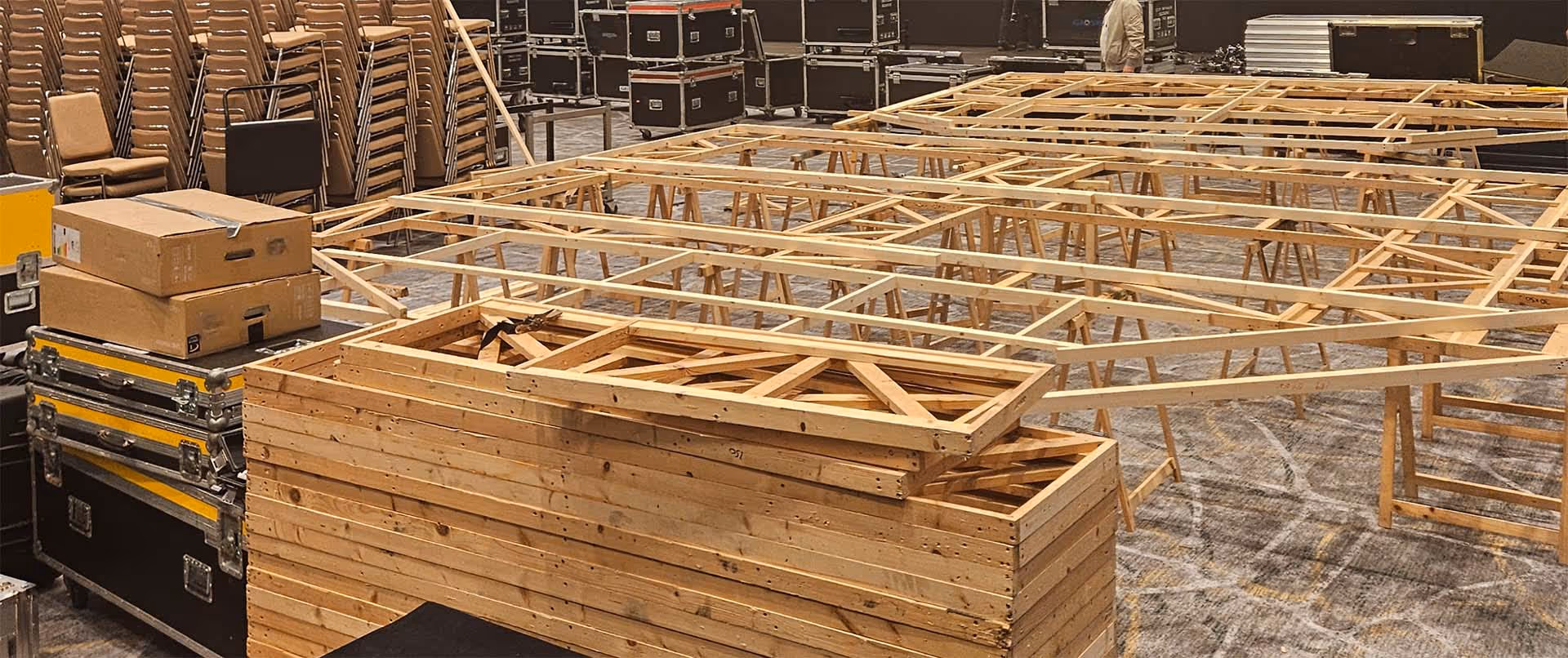 Wooden frame being setup for large bespoke screen at corporate meeting.