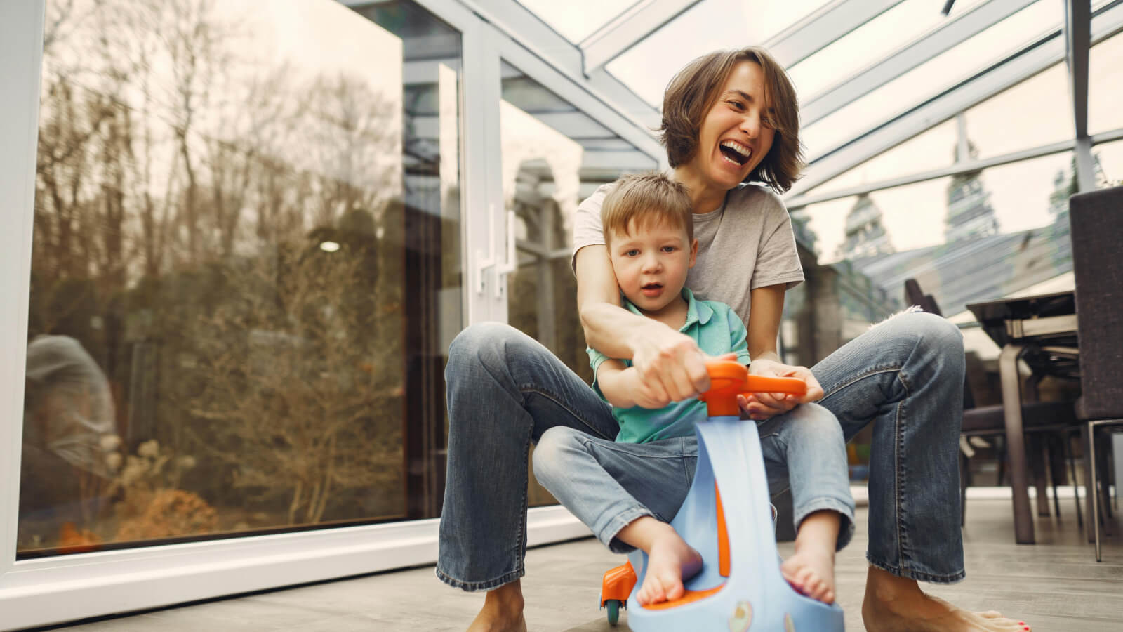 Mom playing on a scooter with her son