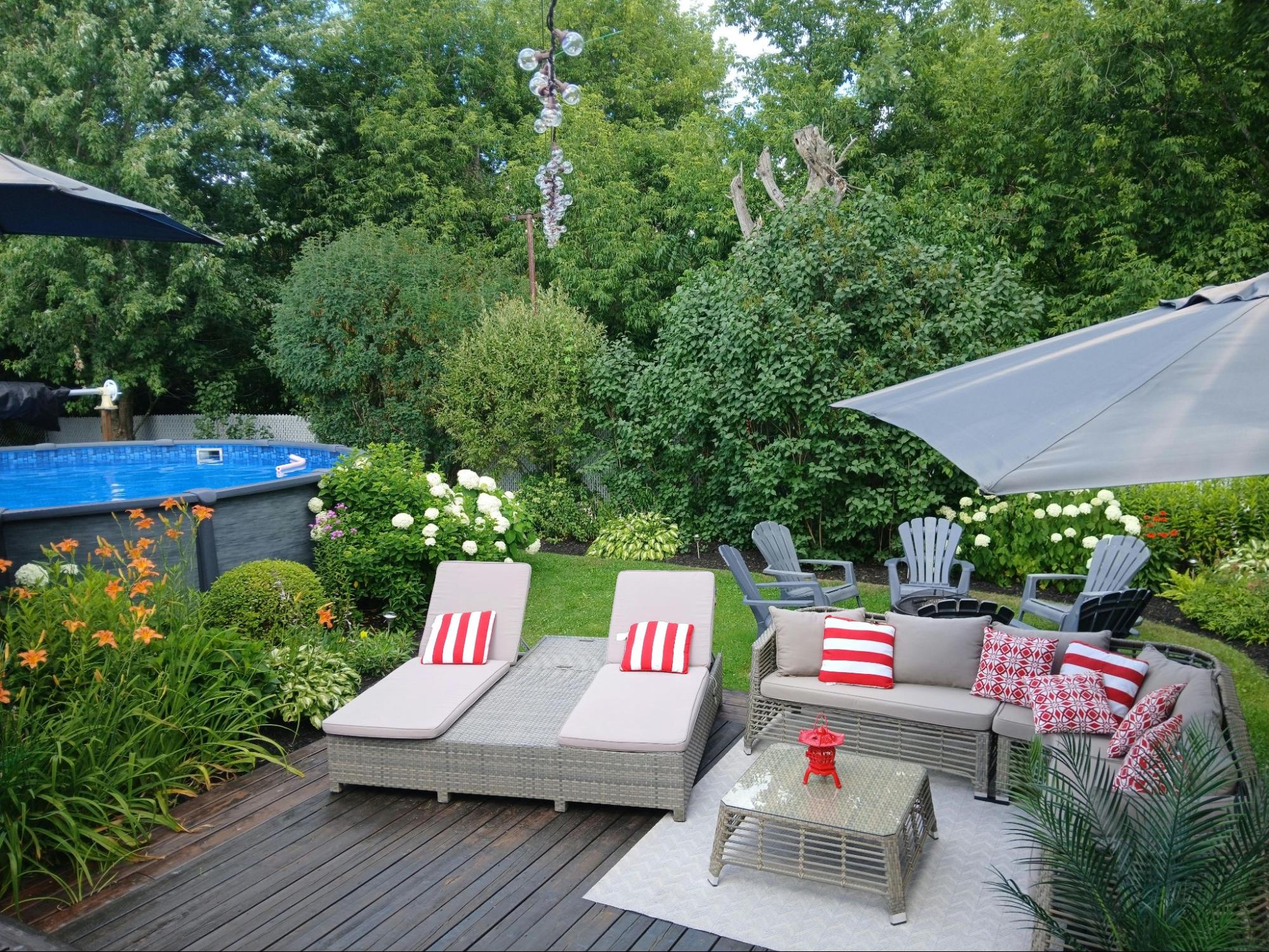 Garden patio with outdoor furniture and colorful flowers.