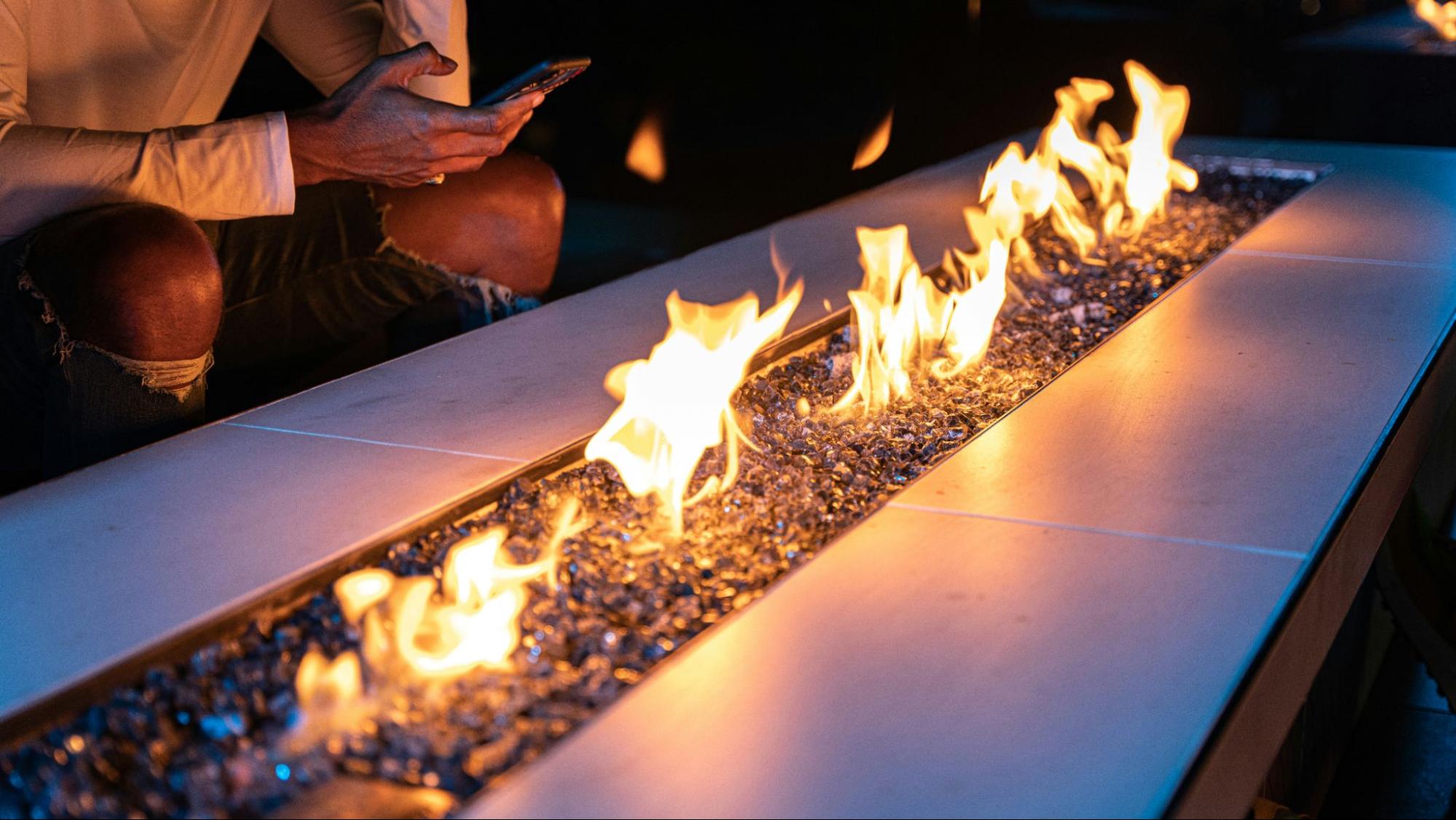 A close shot of an alight fire pit table.