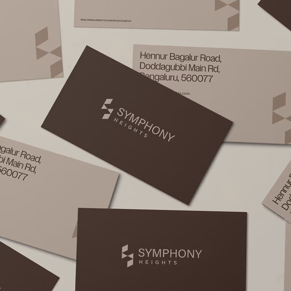 Symphony Heights business cards displayed with warm neutral color palette and geometric logo elements.