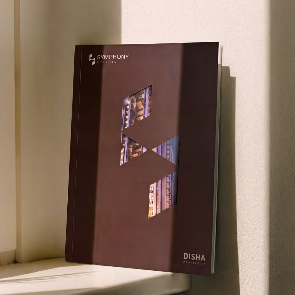 Brochure cover displayed upright showing geometric brand motif and project imagery cutouts.