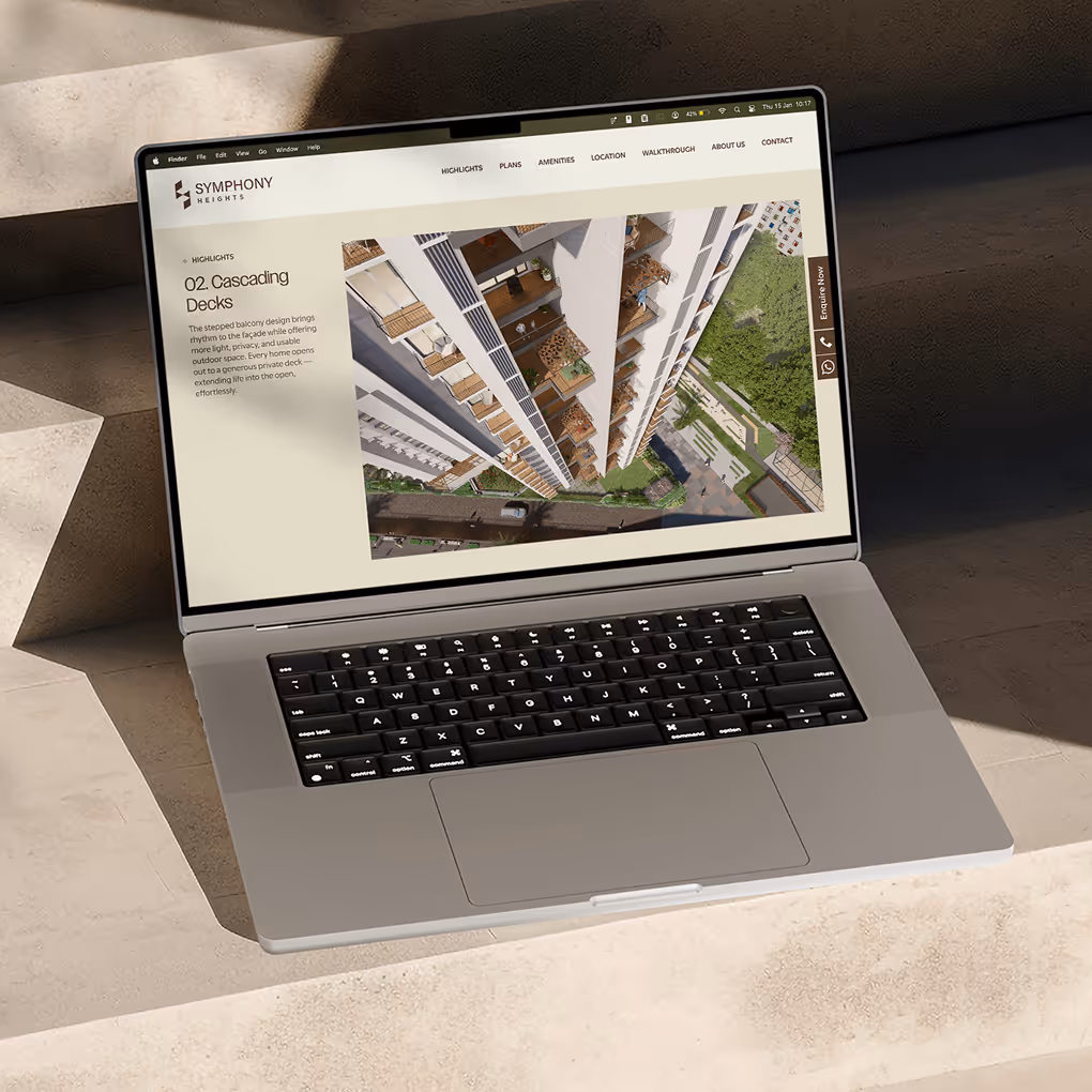 Laptop screen showing website section with cascading balcony visuals and property information.