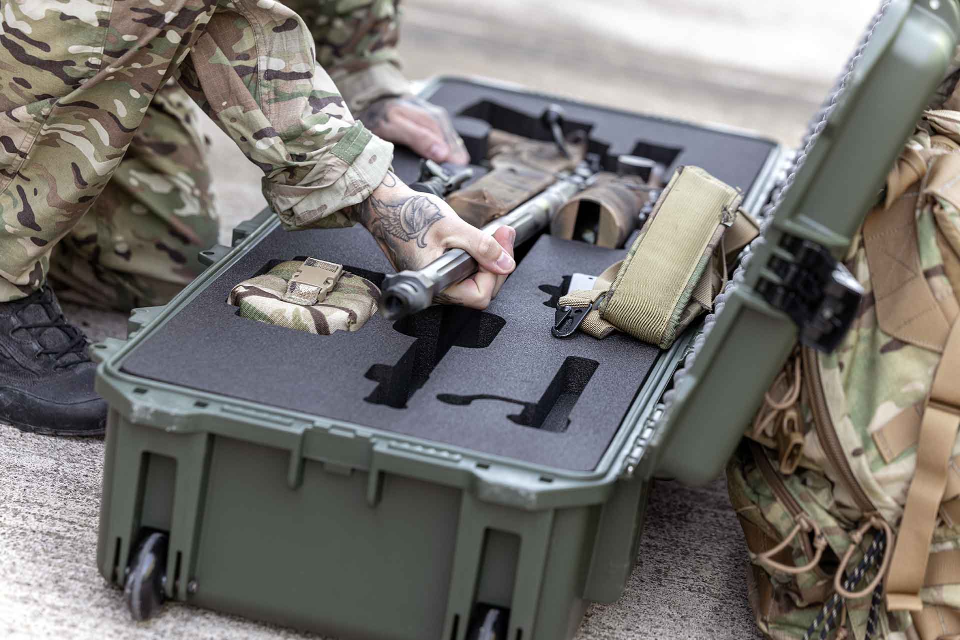 A green Peli 1720 Protector case with custom foam to house military equipment.