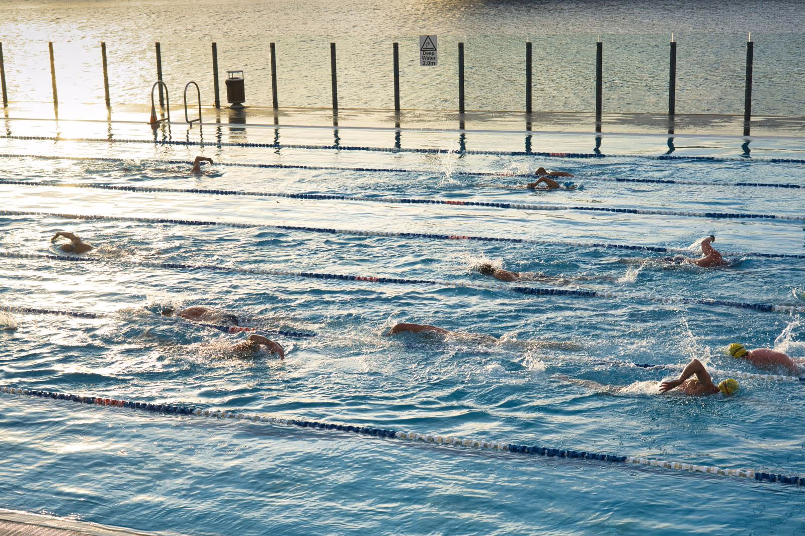 A swimming pool with people swimming in various lanes