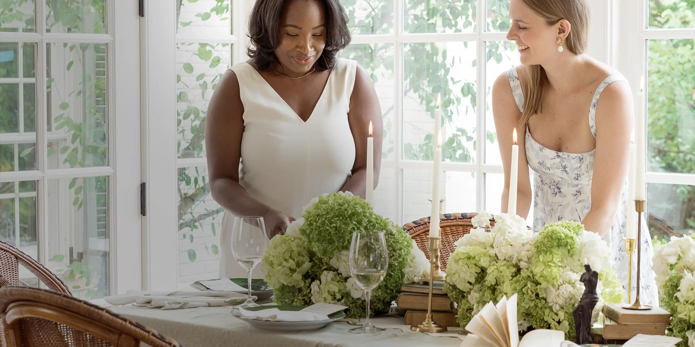 Two women setting the table with The Secret Garden table linens 