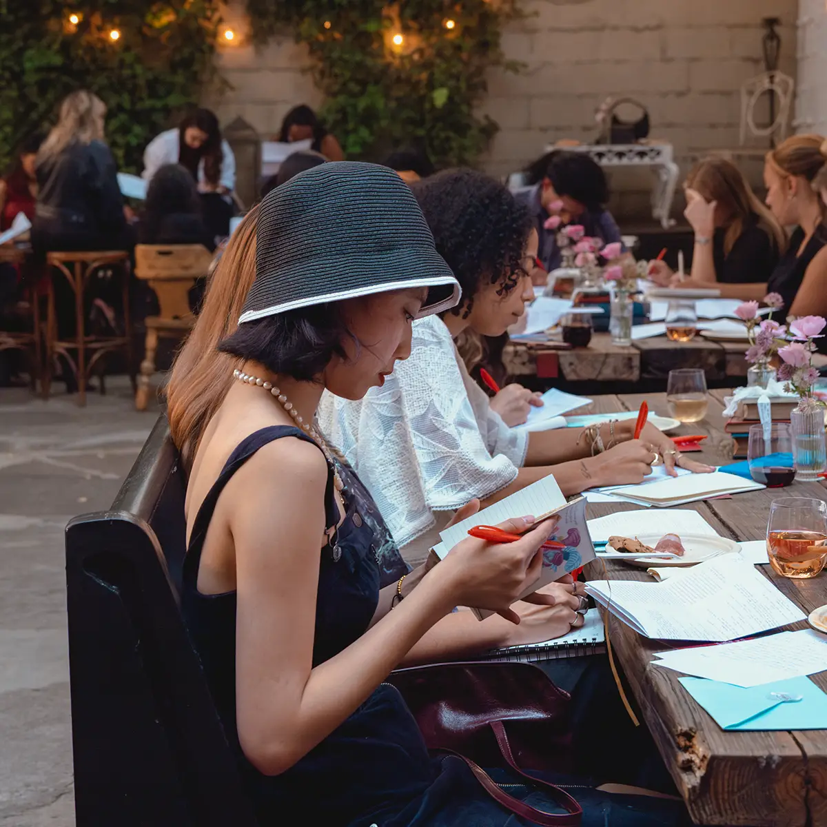 Attendees at a Lit Society event deeply focused reading and writing