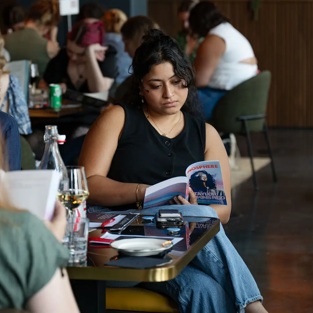 Woman reading a book at a Reading Salon